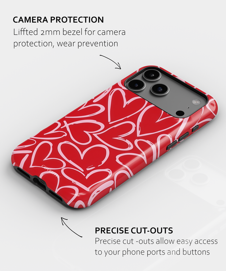 Phone case with red heart pattern and camera protection features on a white background